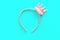 Pink and gold princess crown headband on blue background