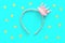 Pink and gold princess crown headband on blue background