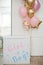 Pink and golden balloons with text `it`s a girl` gender reveal party.