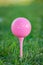 Pink golf ball and tee, symbol of breast cancer fundraising