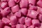 Pink granules of polypropylene or polyamide. Macro photography. Plastics and polymers industry. Copy space.