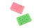 Pink and green washing sponges for dishes isolated on a white background