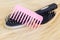 Pink hairbrush on wig in blond color
