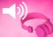 Pink headphones with volume speaker icon