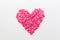 Pink heart made of small hearts on a white background