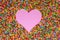 Pink heart shape formed with hundreds and thousands