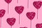 Pink heart shape lollipop pattern on a pink background