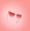 Pink heart shape Valentines day sunglasses flying at pink background