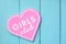 Pink heart-shaped girl club sign on a blue fence background