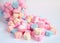 Pink Heart Shaped Marshmallow on the Pile of Pastel Flower Shaped Marshmallow with some in the Glass Jar in Background