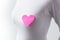 Pink heart shaped sticky note on chest