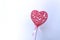 Pink heart on white background. Festive composition with plastic decoration.