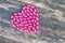 Pink heart on wooden background