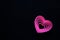 pink hearts on black background for valentine`s day advertising baner