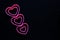 Pink hearts on black background for valentine`s day advertising baner