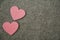 Pink hearts on gray felt background.