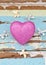 Pink hearts and ribbons on grungy light blue wooden background