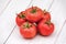 Pink heirloom organic tomatoes on wooden background