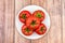 Pink heirloom organic tomatoes on wooden background