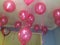 Pink helium balloons floating in a room with an I Love You heart shaped ballon in the corner very romantic Valentine\'s Day idea.