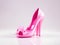 Pink high heel Barbie style shoes with a bow, isolated close-up on a white background