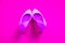 Pink high heeled shoes on pink purple background - top view - heels pigeon toe