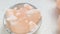 Pink himalaya salt pieces close-up in a gray cup on a light marble background.Pink crystal salt