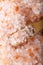 Pink Himalayan salt. Himalayan salt pile. Pink crystal salt in wooden spoon. Food background.