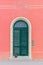 Pink house with a green door in Marina di Pisa