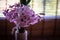 Pink hyacinth flower in homemade vase
