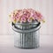 Pink hydrangea flowers in a metal bucket