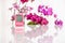 Pink hygrometer on white table with orchids on the background