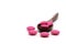 Pink ibuprofen pills in wooden spoon on white background