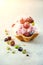 Pink ice cream with berries, strawberries, blueberries, raspberries, pistachios in waffle basket. Summer food concept