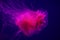 Pink jellyfish in aquarium swimming in dark blue background