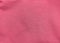 Pink jersey fabric matte texture top view. Red coral knitwear satin background. Fashion color feminine clothes trend