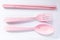 Pink kids and baby cutlery white background