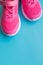 Pink kids training shoes Isolated on blue background.Child clothing, foot wear and fashion.children`s sports sneakers