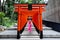 Pink Kimono teen girl hold paper fan  and stand in torii line of Ikuta shrine,Kobe