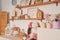 Pink kitchen. Studio apartment. Loft interior. Shelves and spring decor in room. Rent and delivery of housing. Hostel and hotel.