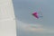 Pink kite in the sky and the white sail yacht, Black Sea, Zatoka, Odesa, Ukraine