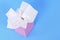 Pink kleenex style tissue box, plain blue background, copy space