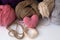 Pink knitted heart of yarn and color skeins of yarn on white table. top view