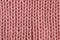 Pink knitted texture for background. Merino yarn. Living coral colour