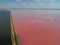 Pink lake Sasyk Sivash. A long road dividing the coast