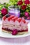 Pink layer cake decorated with fresh fruits