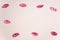 Pink lipstick marks on a white paper