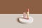 Pink lipstick on a white round podium with shadows on a beige natural background. Wabisabi style, earth tone. Mockup for