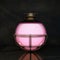 pink liquid in a spherical flask on a black background