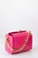 pink little handbag with gold chain isolated on white background. Product photography. bags and purses